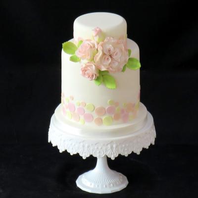 Delicately shaded sugar roses on a pastel spotted Wedding Cake.
