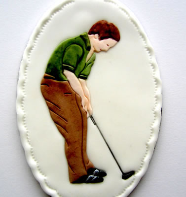 Sugarcraft plaque decorated with a Patchwork Cutter Golfer